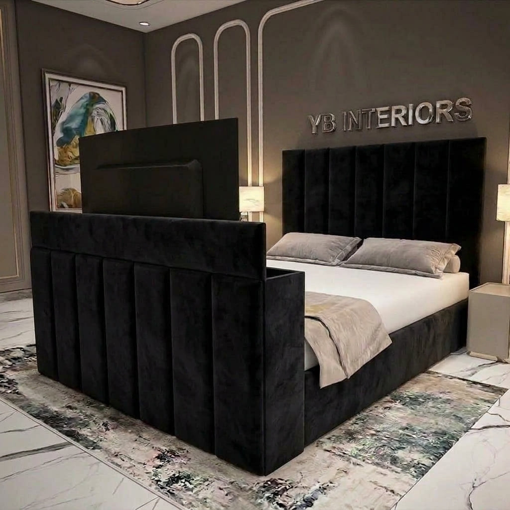 A modern black velvet bed frame with a tall, segmented headboard and matching footboard, styled in a contemporary bedroom setting with gray walls, decorative lighting, and a patterned rug.