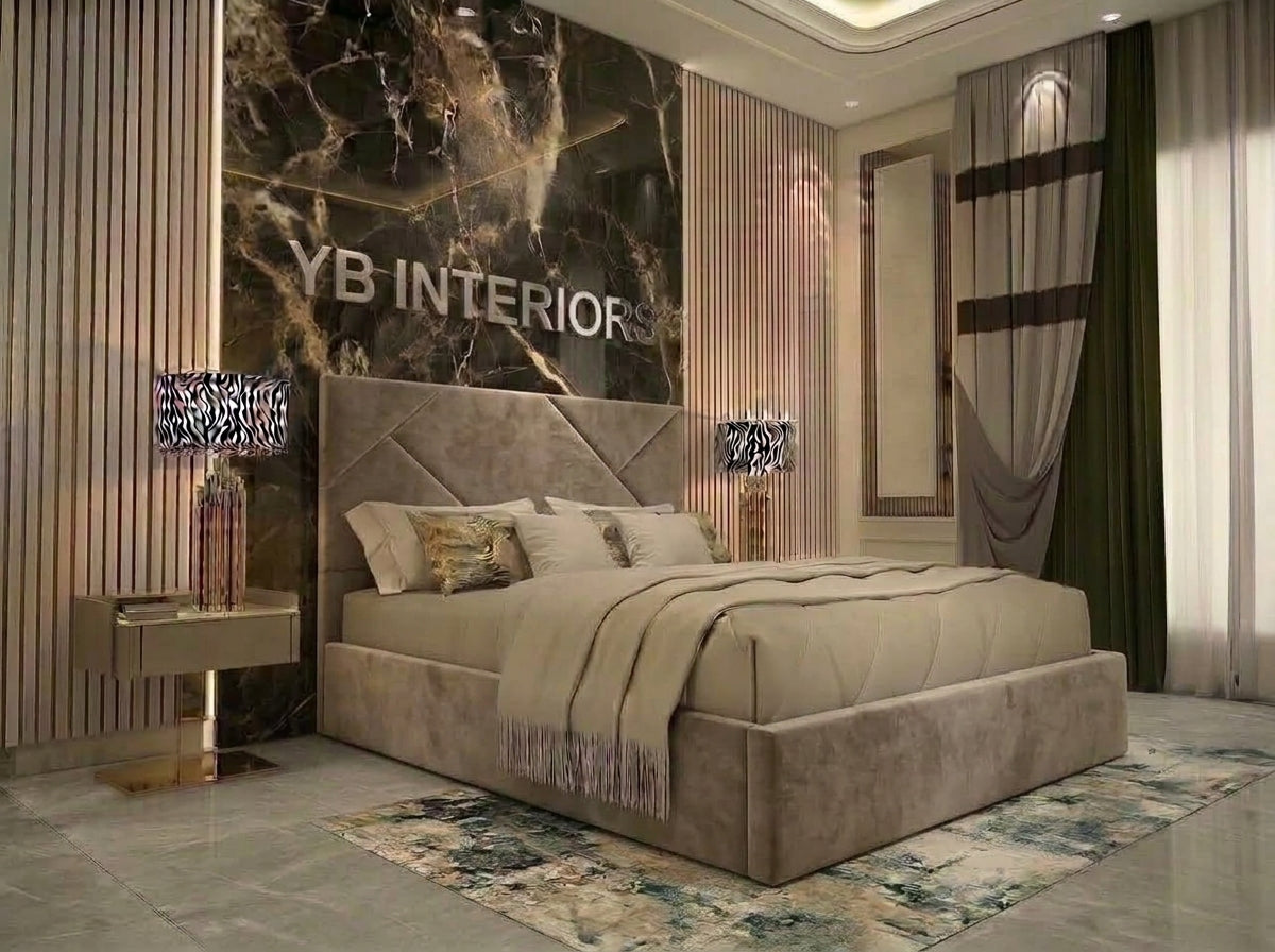 A luxury bedroom featuring a large tufted beige upholstered bed with a matching headboard, styled with neutral-toned bedding and pillows. The background is dominated by a dramatic black and gold marble accent wall with 'YB INTERIOR' text, flanked by vertical wood slats.