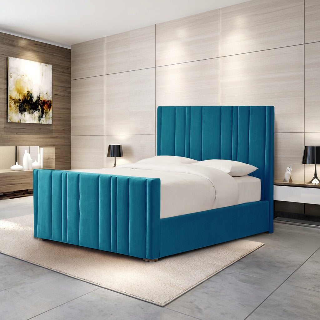 A modern bed frame with a tall, channel-tufted headboard and matching footboard in a vibrant teal blue, styled with white bedding in a contemporary bedroom setting.