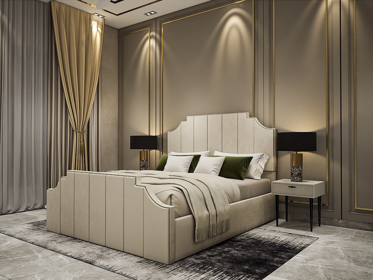 A luxury bedroom featuring a large upholstered bed in cream with a tufted headboard, styled with neutral and green pillows, flanked by two matching bedside tables with black lamps, set against a modern beige wall with gold paneling.