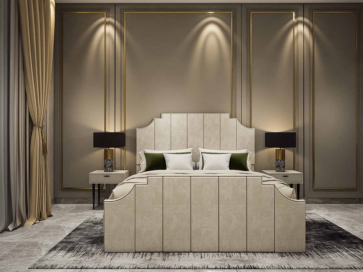 A luxury upholstered bed in a modern, elegant bedroom setting. The bed features a tall, segmented tufted headboard and matching footboard in a light beige fabric, styled with white and green pillows.
